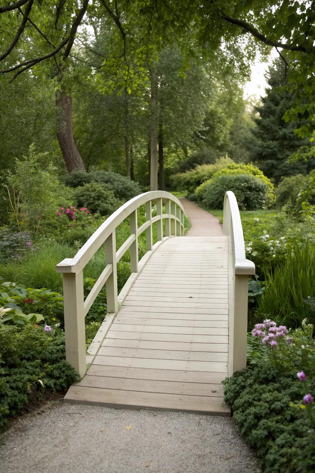 A minimalist arch bridge offers understated elegance in a garden.