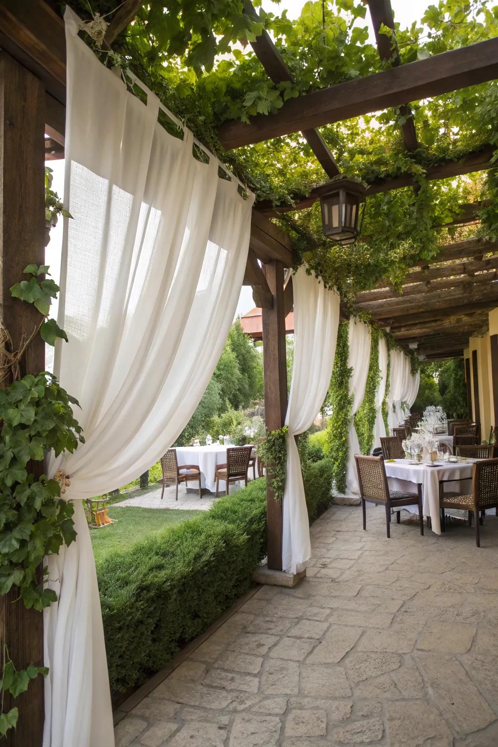 Curtains add privacy and coziness to pergola dining.