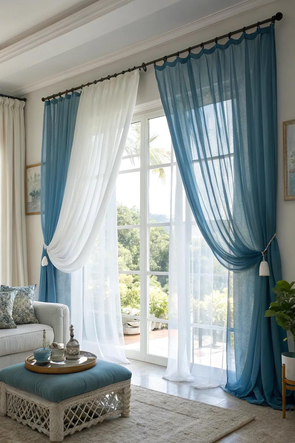Combining blue curtains with white sheers softens the sunlight and adds privacy while keeping the room bright.